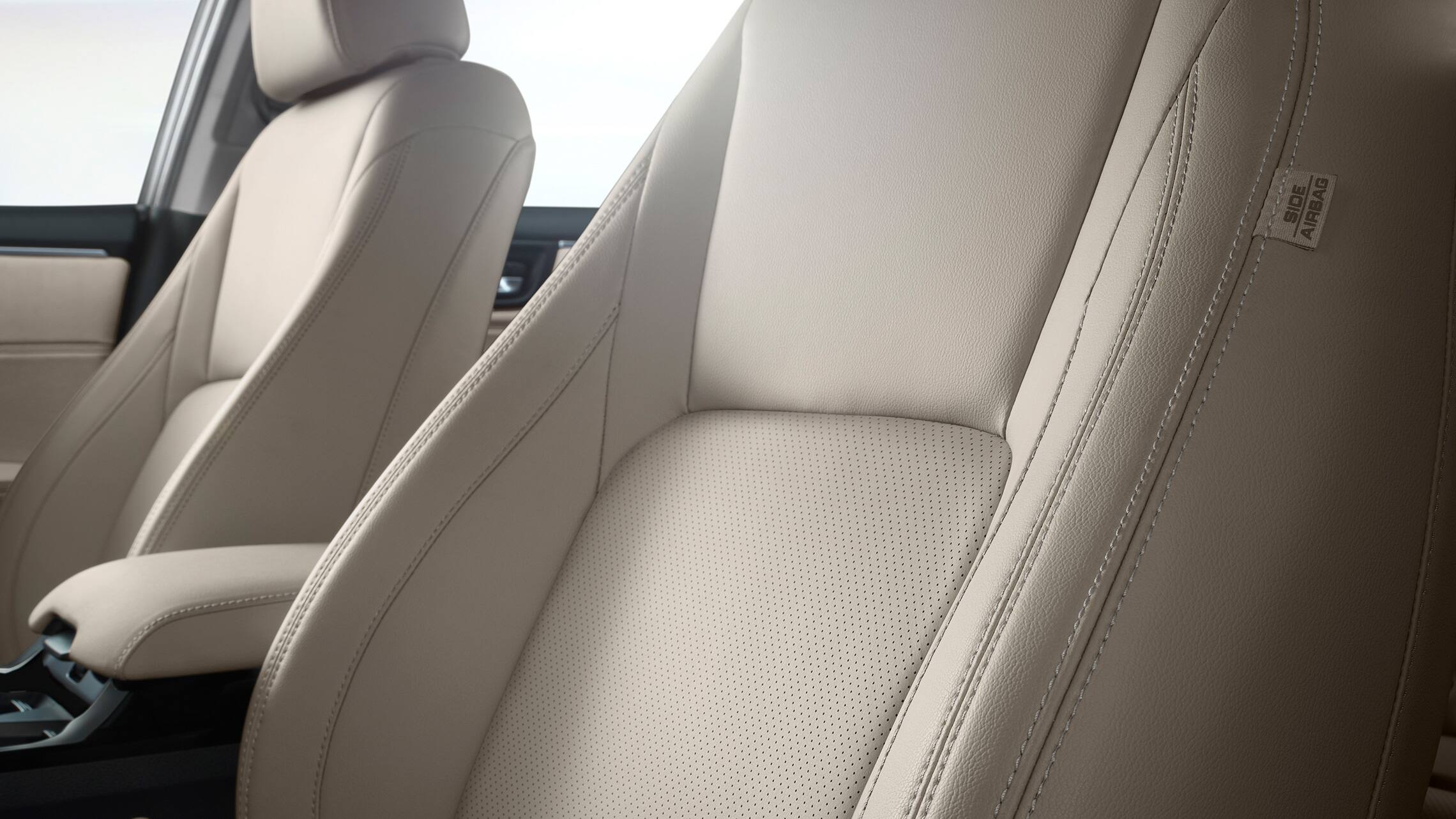Detail of perforated seating surfaces in Beige Leather.